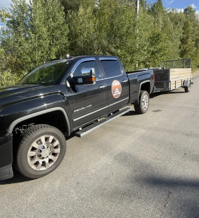 Lima Haul Co.'s truck and trailer on a Southern New Hampshire road, ready to haul job-site debris